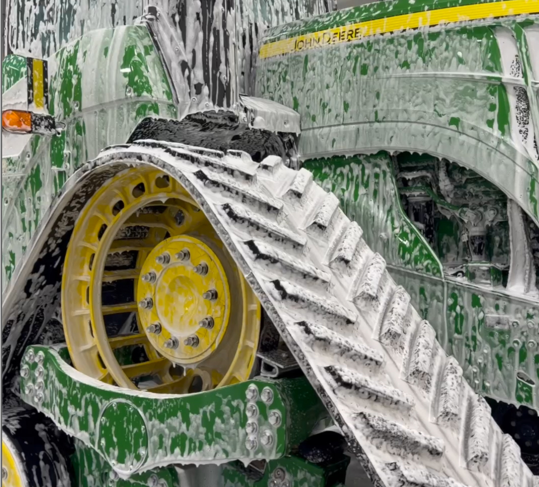 ProFoam tractor foam cleaner clinging to a tractor